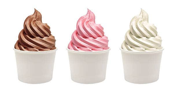 Blank paper cups with frozen yogurt on white background